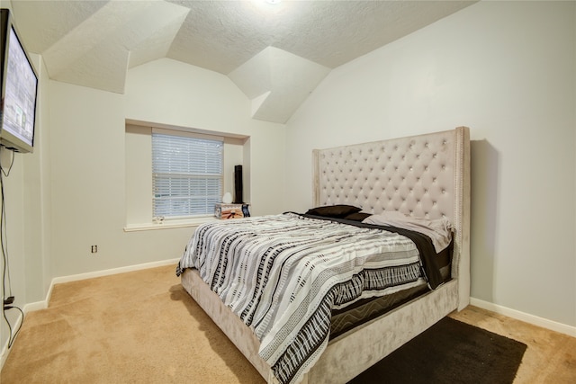 carpeted bedroom featuring a textured ceiling and vaulted ceiling