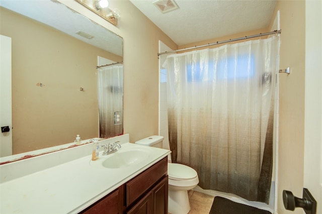 bathroom featuring a shower with shower curtain, a textured ceiling, vanity, tile patterned flooring, and toilet