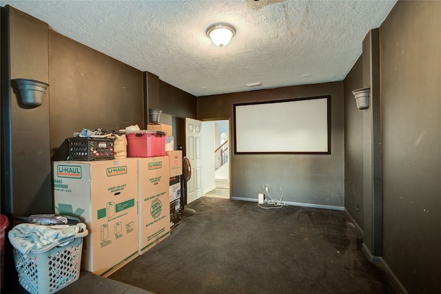 carpeted home theater with a textured ceiling