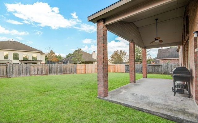 view of yard with ceiling fan and a patio area