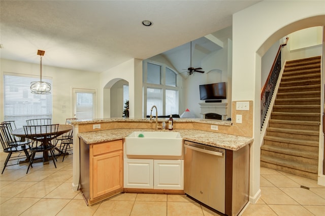 kitchen featuring ceiling fan, dishwasher, a healthy amount of sunlight, and vaulted ceiling