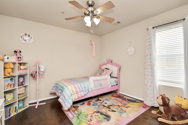 bedroom with dark hardwood / wood-style floors and ceiling fan