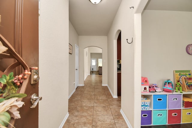 hall with light tile patterned floors