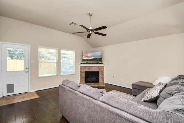 living room with ceiling fan, wood-type flooring, a fireplace, and vaulted ceiling