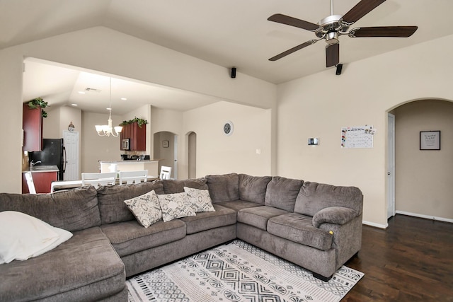 living room with ceiling fan with notable chandelier, dark hardwood / wood-style flooring, lofted ceiling, and sink