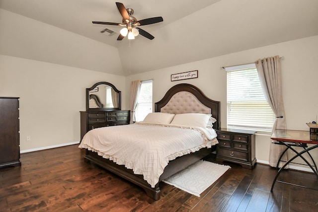 bedroom featuring dark hardwood / wood-style flooring, multiple windows, lofted ceiling, and ceiling fan