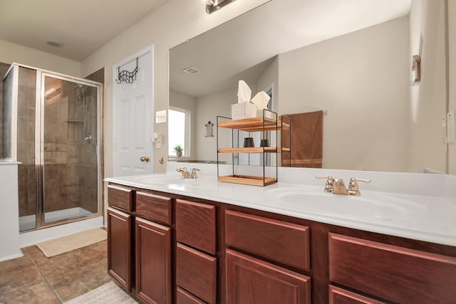 bathroom featuring vanity, tile patterned floors, and walk in shower