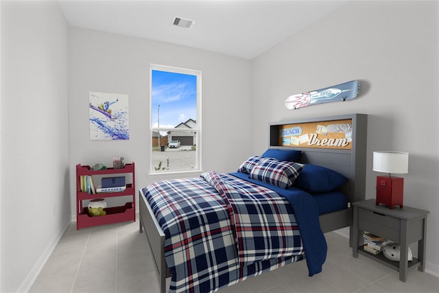 bedroom featuring light tile patterned floors, baseboards, and visible vents