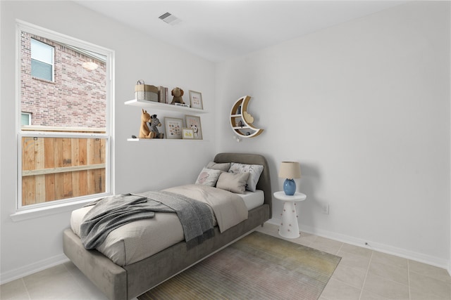 bedroom with visible vents, baseboards, and light tile patterned flooring