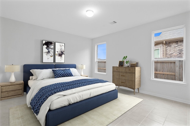 bedroom with baseboards, visible vents, and light tile patterned flooring