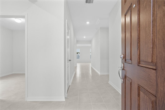 hallway featuring recessed lighting, visible vents, baseboards, and light tile patterned flooring