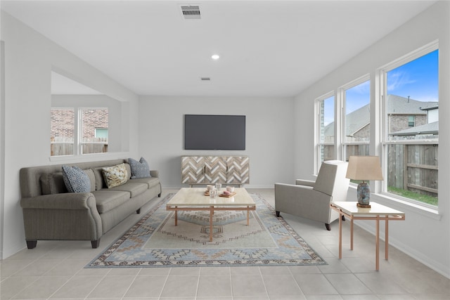 living area featuring visible vents, baseboards, and light tile patterned floors