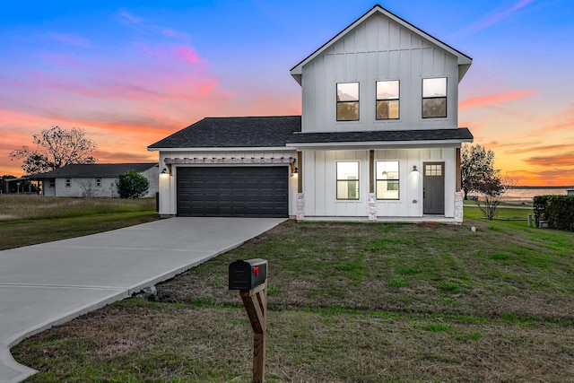 modern farmhouse style home featuring a lawn, covered porch, and a garage