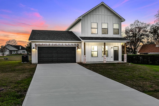 modern inspired farmhouse with a lawn, covered porch, and a garage