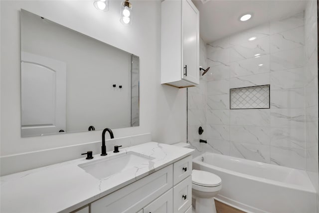 full bathroom with tiled shower / bath combo, toilet, and vanity