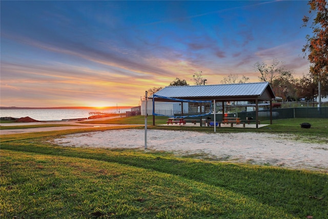 view of property's community featuring a gazebo, a water view, volleyball court, and a lawn