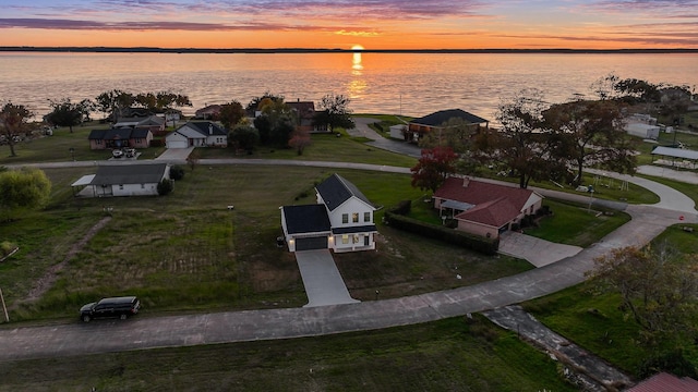 aerial view at dusk with a water view