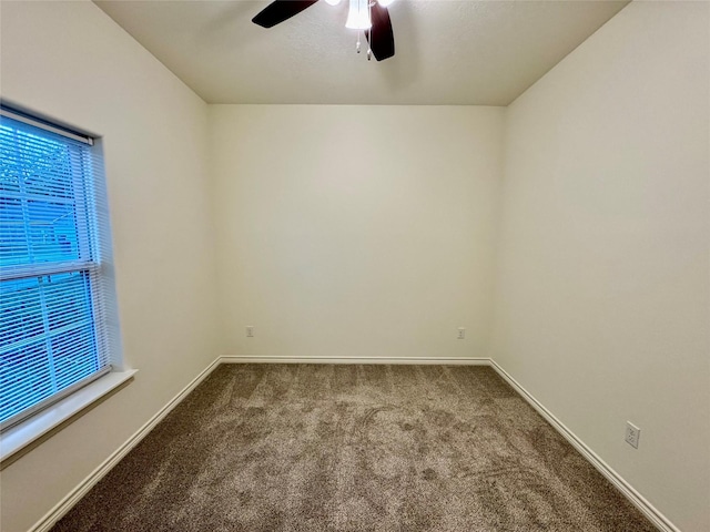 carpeted spare room with ceiling fan