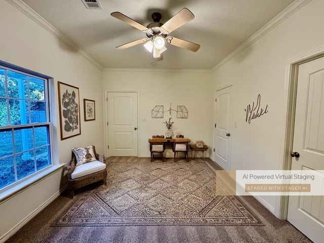 living area with ceiling fan, carpet, and ornamental molding