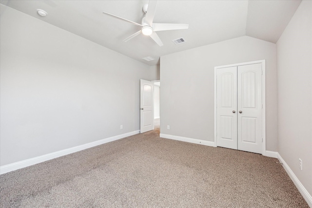 unfurnished bedroom with carpet floors, a closet, ceiling fan, and lofted ceiling