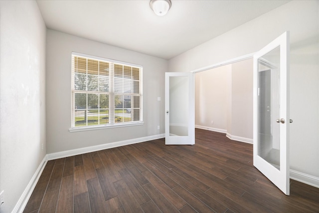 unfurnished bedroom featuring dark hardwood / wood-style flooring and french doors