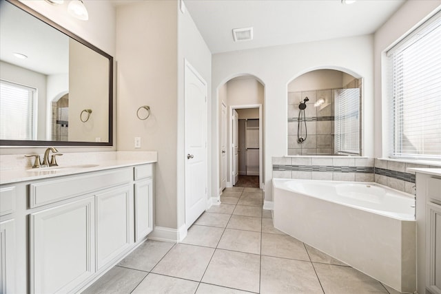 bathroom featuring tile patterned floors, vanity, and independent shower and bath