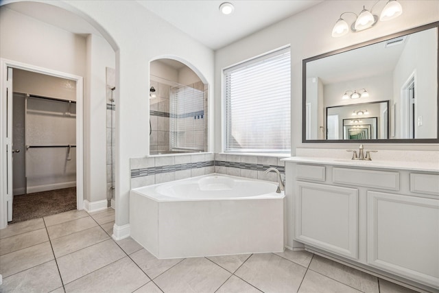 bathroom with tile patterned floors, vanity, and independent shower and bath