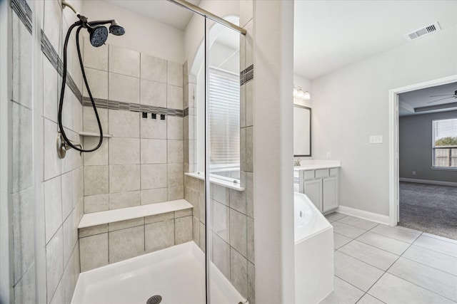 bathroom featuring tile patterned flooring, vanity, a shower with door, and ceiling fan