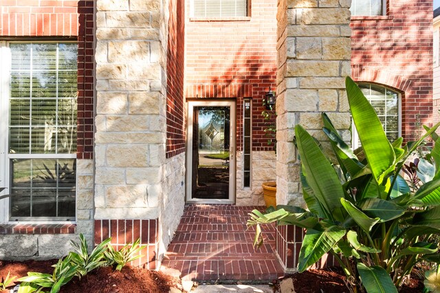 411 White Oak Pointe, League City, TX 77573 - doorway to property with brick siding and stone siding