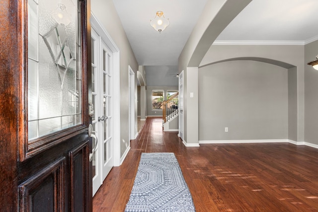 entryway with french doors, dark hardwood / wood-style floors, and crown molding