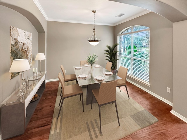 dining room featuring dark hardwood / wood-style flooring and ornamental molding