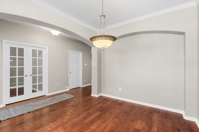 411 White Oak Pointe, League City, TX 77573 - empty room featuring baseboards, arched walkways, dark wood-type flooring, and ornamental molding