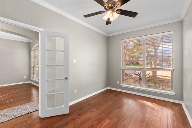 411 White Oak Pointe, League City, TX 77573 - unfurnished room with baseboards, arched walkways, wood finished floors, and crown molding