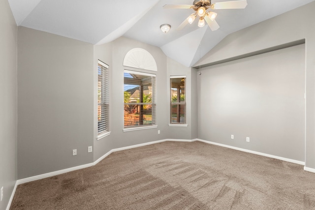 unfurnished room featuring ceiling fan, carpet floors, and vaulted ceiling