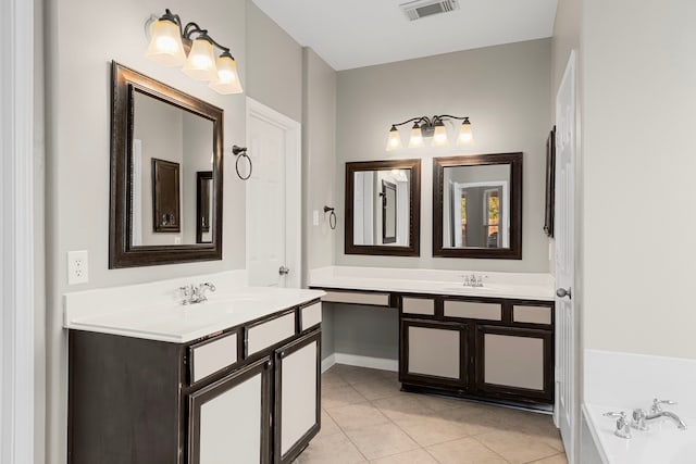 bathroom featuring tile patterned flooring, vanity, and a bathtub