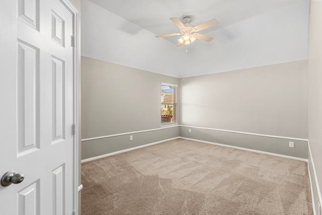 carpeted empty room with ceiling fan and lofted ceiling