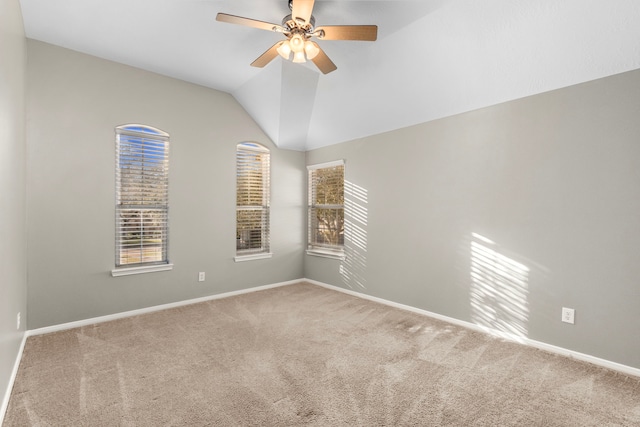 carpeted empty room featuring ceiling fan and lofted ceiling