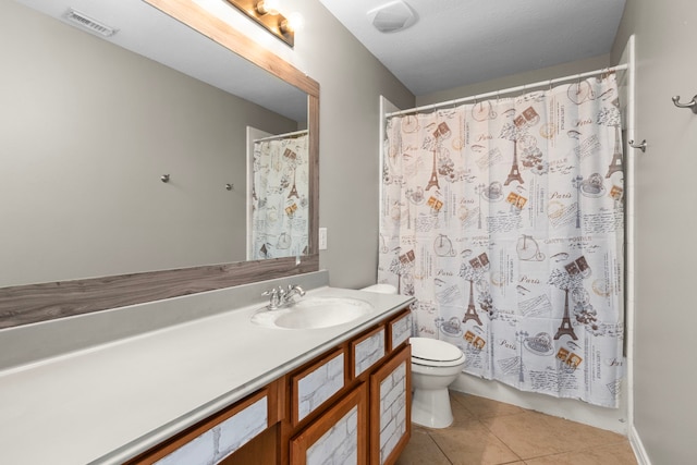 bathroom featuring tile patterned floors, vanity, and toilet