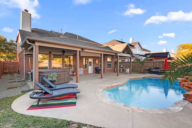 view of pool featuring a hot tub, grilling area, and a patio area