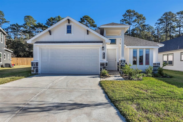 view of front of property with a front yard and a garage