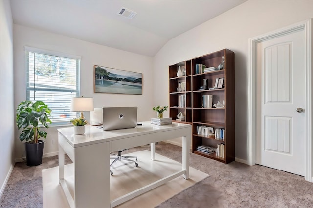 office space with light colored carpet and lofted ceiling