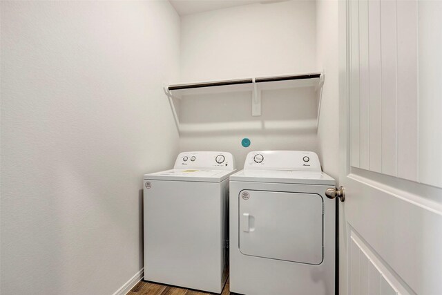 washroom with washer and dryer and wood-type flooring