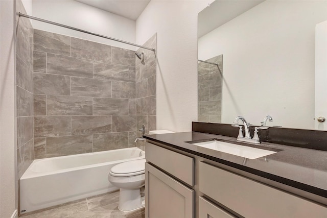 full bathroom featuring toilet, vanity, and tiled shower / bath