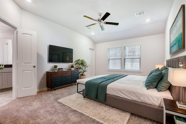 bedroom featuring light colored carpet, vaulted ceiling, and ceiling fan