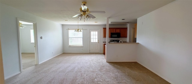 interior space featuring ceiling fan with notable chandelier and light carpet