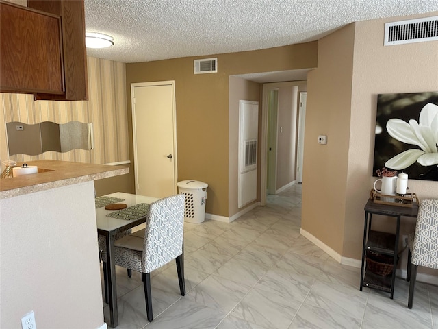 dining area featuring a textured ceiling