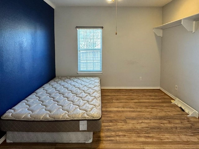 unfurnished bedroom with hardwood / wood-style floors