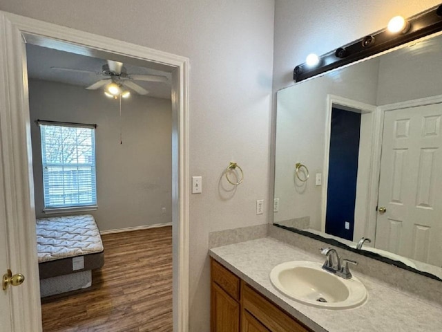 bathroom with hardwood / wood-style flooring, vanity, and ceiling fan