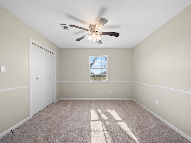 unfurnished bedroom with ceiling fan, a closet, and carpet floors