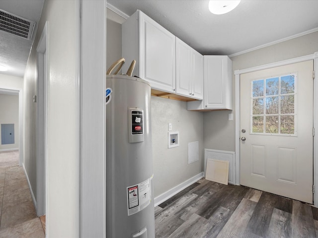 laundry area with cabinets, washer hookup, dark hardwood / wood-style flooring, ornamental molding, and electric water heater